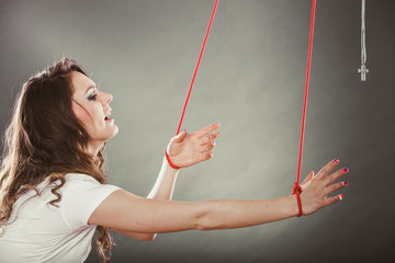 Tied woman forced to pray. Fake faith. Religion.