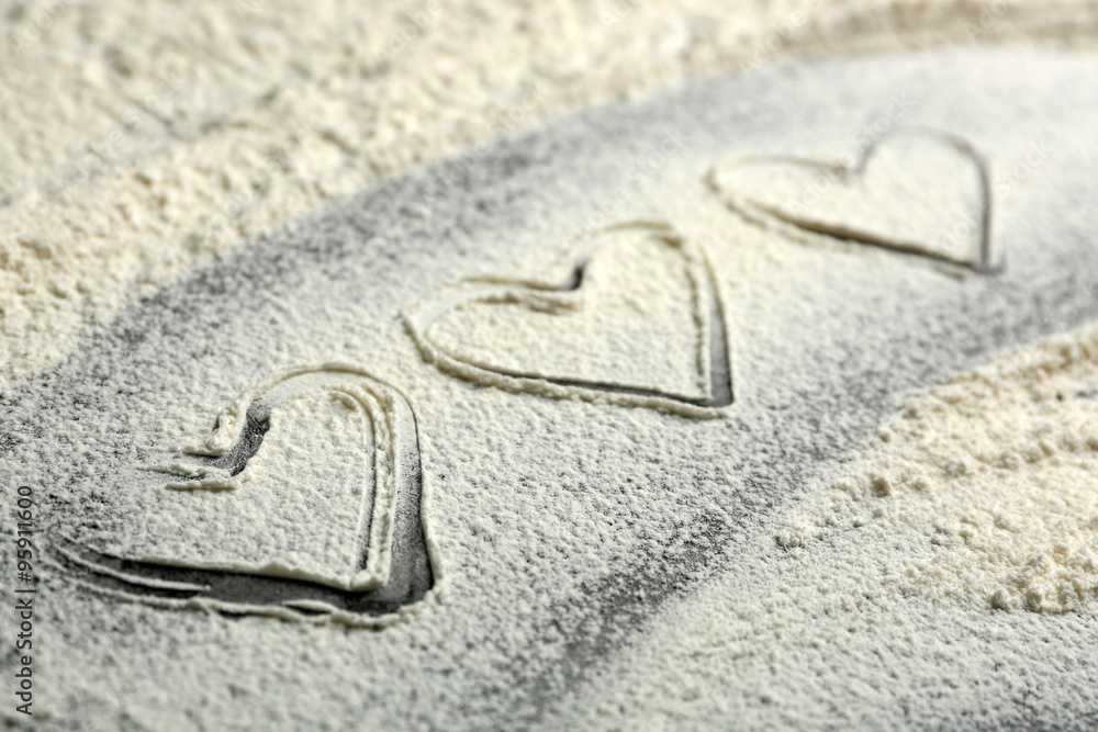 Hearts of flour on gray background