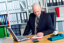 Young Businessman With Bald Head In The Office