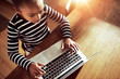 © Flamingo Images - Young ethnic black girl typing on a laptop