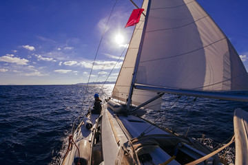 Wall Mural - Sailing boat wide angle view in the sea at sunset