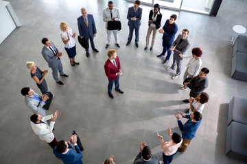 Wall Mural - Business team with leader in centre of circle.