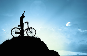 Wall Mural - Man and bicycle on mountain in the sunlight