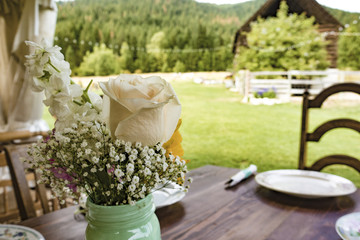 Wedding Table Settings With Flowers, Utensils, Chairs and Dishes