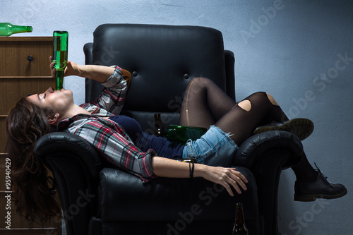 Fotografie, Obraz Drunk Woman Laying on Armchair Drinking Beer