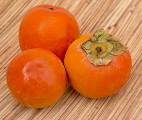 ripe persimmon on a wooden background