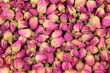Background of a large quantity of dried buds pink tea rose.