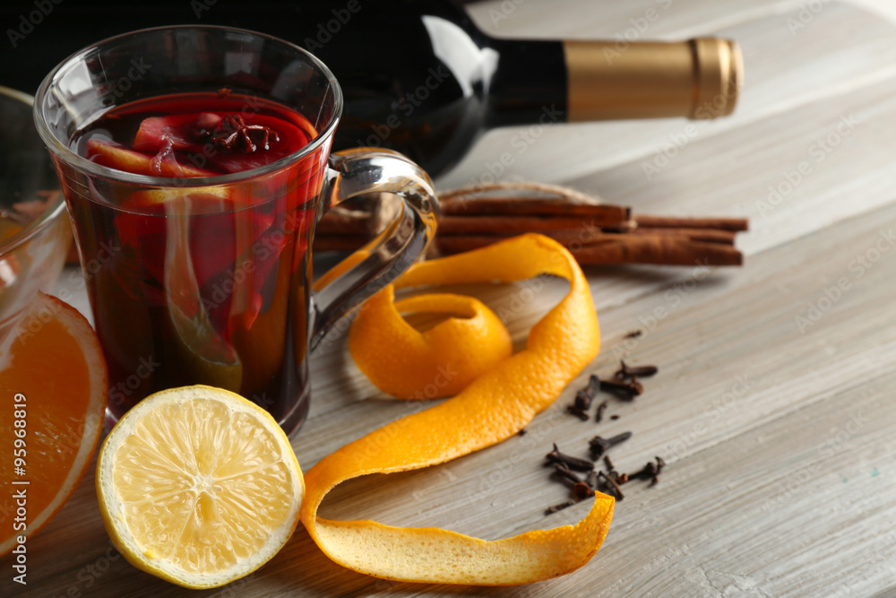 Beautiful composition of traditional mulled wine with decorations on the table