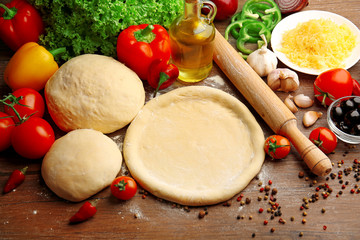 Canvas Print - Dough basis and ingredients for pizza, on the table