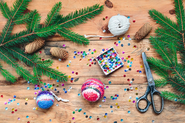 Making Christmas ball pinning the sequins onto the ball