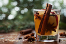 Christmas Mulled Apple Cider With Spices Cinnamon, Cloves, Anise And Honey On Rustic Table, Traditional Drink On Winter Holiday, Magical Evening Light, Selective Focus