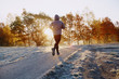 © baranq - Young man running at park during cold autumn morning.