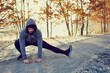 © baranq - Male runner doing stretching exercise