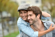 © goodluz - Portrait of man giving piggyback ride to girlfriend