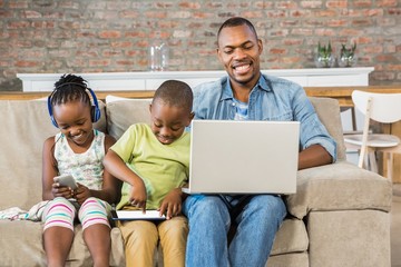 Wall Mural - Happy family using technology together