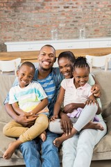 Wall Mural - Happy family relaxing on the couch