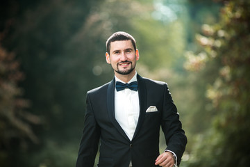 confident groom posing