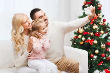 Canvas Print - family taking selfie with smartphone at christmas