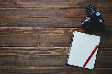 notebook and vintage camera on the desk