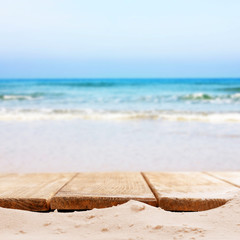 Poster - Sand with wooden planks on sea background