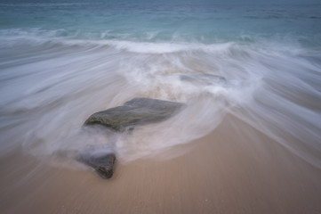 wave and stone in sea