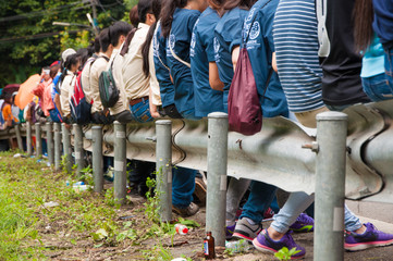 people sit on roadside