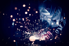 Employee Welding Steel With Sparks Using Mig Mag Welder - Focus On Sparks.