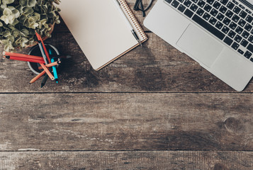 Canvas Print - Notebook and laptop on old wooden desk