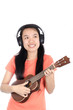 © nungning20 - Happy asian woman is  playing ukulele and listening the song with smile on white background
