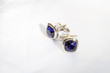 © Slimp - Men's cuff links made of white metal with a blue stone on white background