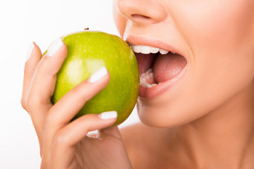 Canvas Print - Closeup photo of a beautiful healthy girl biting an apple