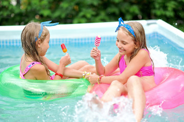 Wall Mural - Portrait of two girls in a swimming pool