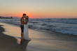 © Stockphototrends - Just married young couple on a hazy beach at dusk.