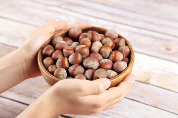 Wall Mural - Hazelnuts in a wooden bowl