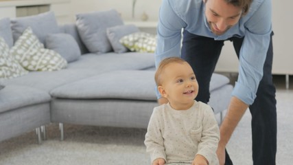 Wall Mural - Daddy and baby girl playing with child car