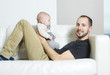 © Louis-Paul Photo - Father with baby on the sofa taking good time