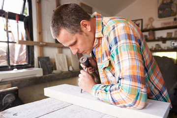 Wall Mural - Stone Mason At Work On Carving In Studio