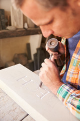 Wall Mural - Stone Mason At Work On Carving In Studio