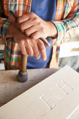Wall Mural - Close Up Of Stone Mason At Work On Carving In Studio