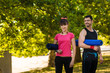 © illustrissima - Man and woman holds sport mats outdoor
