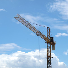 Industrial landscape with cranes on the blue sky