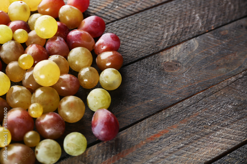 Juicy grapes berries on wooden background