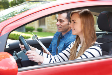 woman having driving lesson with instructor