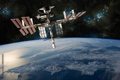 Fotografie, Obraz A depiction of the space shuttle docked at the international space station orbiting Earth