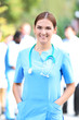 © Africa Studio - Attractive woman doctor standing against unfocused group of medics, outdoors
