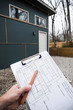 © goodmanphoto - worker holding blueprints with building in the background