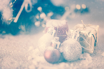 Wall Mural - Vintage Christmas balls and gift boxes over snow background