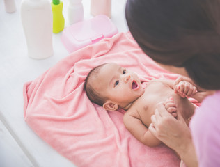 Wall Mural - happy baby playing with her mother after being bahted