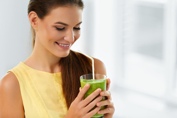 Wall Mural - Healthy Food And Eating. Happy Young Woman Drinking Green Detox Vegetable Smoothie. Healthy Lifestyle, Vegetarian Diet And Meal. Drink Juice. Health Care And Beauty Concept.