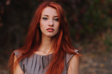 Outdoors Portrait Of Beautiful Young Woman With Red Hair